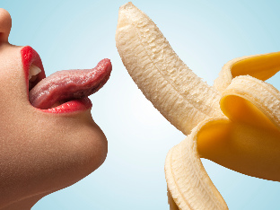 Girl licks a banana